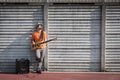 Young musician playing bass guitar