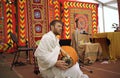 Young musician singing in microphone and playing Indian musical instruments for meditation