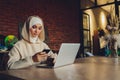 Young muslim asian female designer using graphics tablet while working with computer at studio or office. Royalty Free Stock Photo