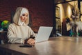 Young muslim asian female designer using graphics tablet while working with computer at studio or office. Royalty Free Stock Photo