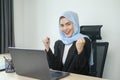 Young muslim business woman working on laptop with documents in modern office Royalty Free Stock Photo