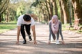 Muslim man and woman in starting position preparing for run Royalty Free Stock Photo