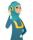 Young muslim customer service operator in headset. Royalty Free Stock Photo