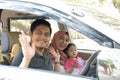 Young muslim family , transport, leisure, road trip and people concept - happy man, woman and little girl waving at camera ready Royalty Free Stock Photo