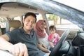 Young muslim family , transport, leisure, road trip and people concept - happy man, woman and little girl traveling in a car Royalty Free Stock Photo