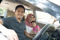 Young muslim family , transport, leisure, road trip and people concept - happy man, woman and little girl traveling inside a car Royalty Free Stock Photo