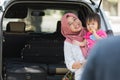 Young muslim family , transport, leisure, road trip and people concept - happy woman and little girl smilling at father to say Royalty Free Stock Photo