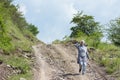 Young muslim girl wearing sport clothes walking alone on the rural mountain road