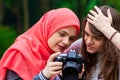 Young muslim girls watching photos on the professional camera Royalty Free Stock Photo