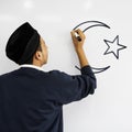 Young Muslim man writing on a whiteboard Royalty Free Stock Photo
