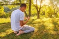 Young Muslim man pray in nature at sunset time