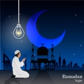 Young muslim man praying on blue background