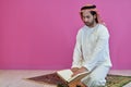 Young muslim man reading Quran during Ramadan