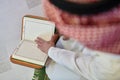 Young muslim man reading Quran during Ramadan