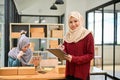 Young Muslim online start up business team working together, checking order with tablet Royalty Free Stock Photo