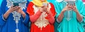 Young Muslim people using their mobile smart phones in the college - Arabian girls addicted to new technology app cellphone Royalty Free Stock Photo