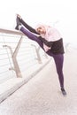 Calm woman stretching muscles on the bridge stock photo Royalty Free Stock Photo