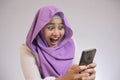 Young Muslim Woman Get Good News on Her Phone Royalty Free Stock Photo