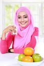 Young muslim woman had a milk and fruits for breakfast Royalty Free Stock Photo