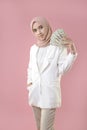 Young muslim woman hold money on isolated background Royalty Free Stock Photo