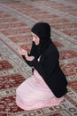 Young muslim woman praying