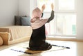 Young Muslim woman praying at home Royalty Free Stock Photo