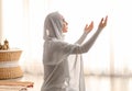 Young Muslim woman praying at home Royalty Free Stock Photo