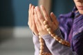 Young Muslim woman with rosary beads praying at home, closeup Royalty Free Stock Photo