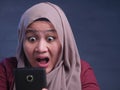 Young Muslim Woman Shocked Expression, Looking at Her Phone Royalty Free Stock Photo