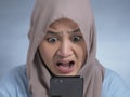 Young Muslim Woman Shocked Expression, Looking at Her Phone Royalty Free Stock Photo