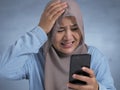 Young Muslim Woman Shocked Expression, Looking at Her Phone Royalty Free Stock Photo