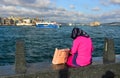 Young muslim woman sitting at pier