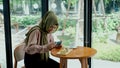 Young muslim woman take a picture cake with smartphone