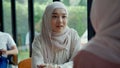 Young muslim woman talking with her friend in coffee shop Royalty Free Stock Photo