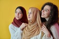 Young muslim women posing on yellow background Royalty Free Stock Photo