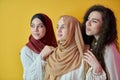 Young muslim women posing on yellow background Royalty Free Stock Photo