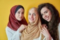 Young muslim women posing on yellow background Royalty Free Stock Photo