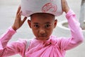 Young Myanmar nun carrying rice