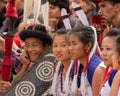 Young Naga boys and girls siting together wearing colorful attire