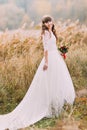 Young naive bride posing outdoors. Cute charming girl with forest hills on background Royalty Free Stock Photo