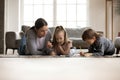 Young nanny babysitter drawing picture with small children.