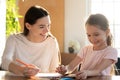 Young nanny tutor educating little preschool child girl. Royalty Free Stock Photo