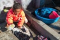 Young Nepal Child Girl Living in Poverty Working Washing Clothes Young Age