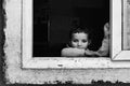Young Nepalese girl peering from a window