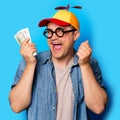 Young nerd man with noob hat holding a money