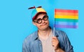 Nerd man with noob hat holding a rainbow flag