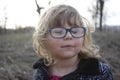 Young nerdy girl with glasses aged 3-5, blonde hair, blue eyes. Preschooler portraits