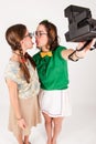 Young nerdy girls taking a selfie with instant cam Royalty Free Stock Photo