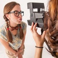 Young nerdy girls using instant camera. Royalty Free Stock Photo