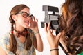 Young nerdy girls using instant camera. Royalty Free Stock Photo